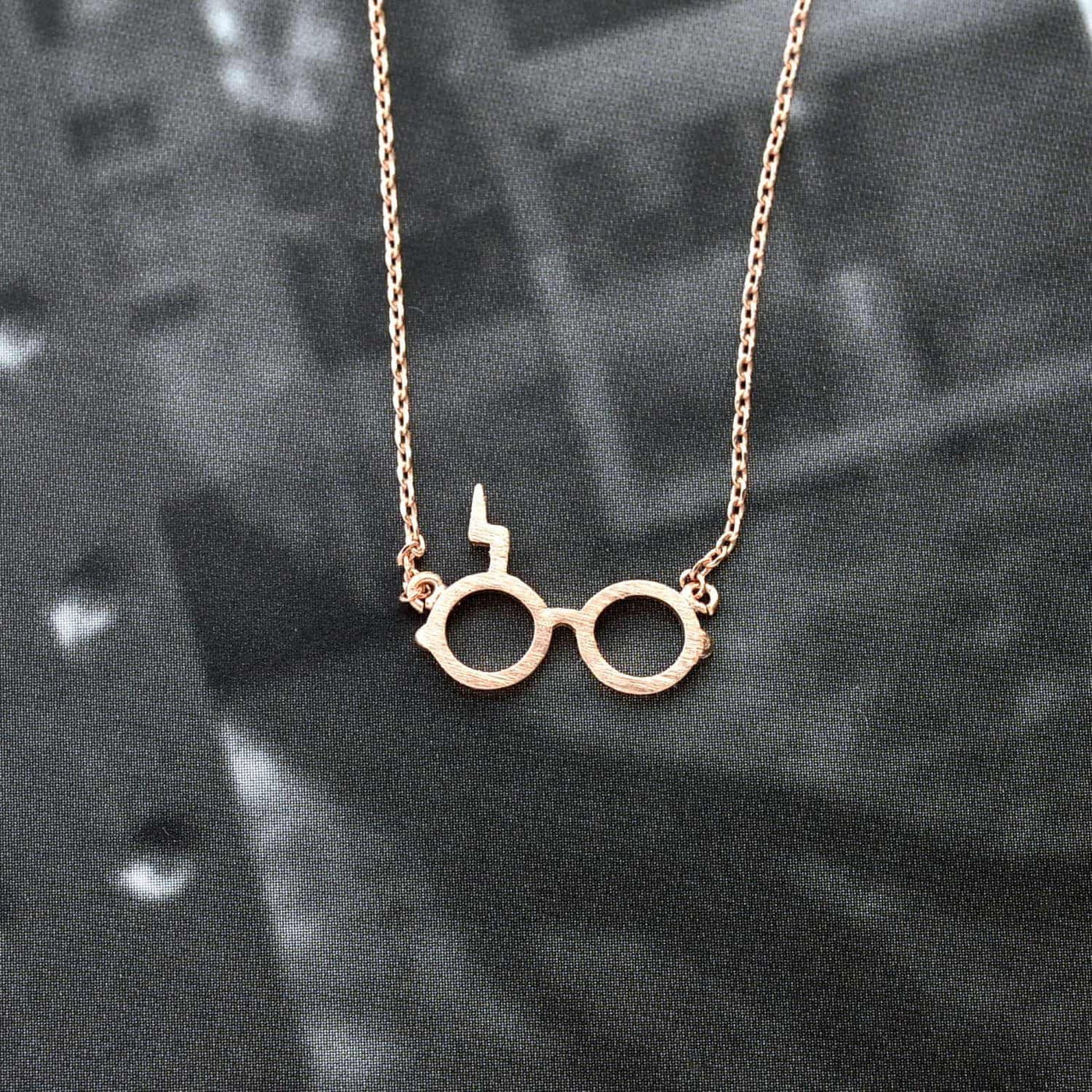 Collier Harry Potter Fumseck plaqué or rose